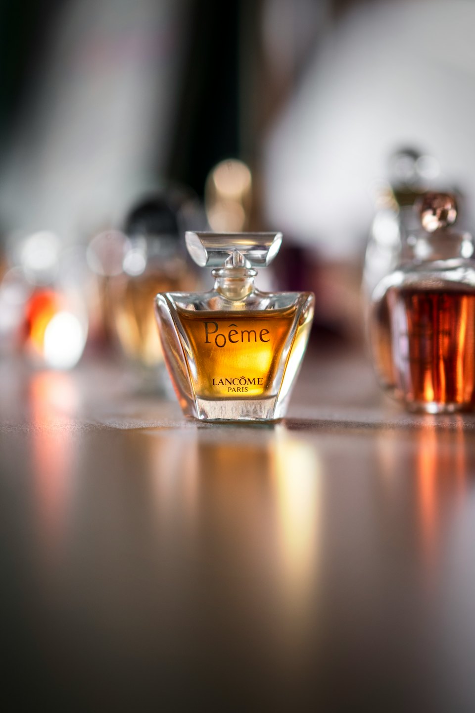 A golden perfume bottle on a polished surface.